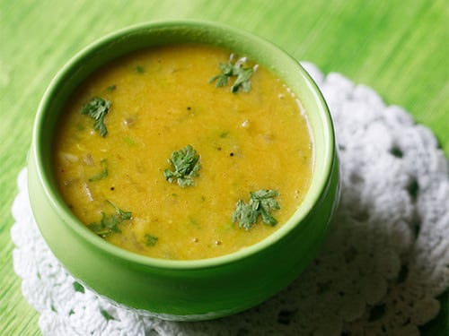 mamidikaya pappu served in a green bowl.