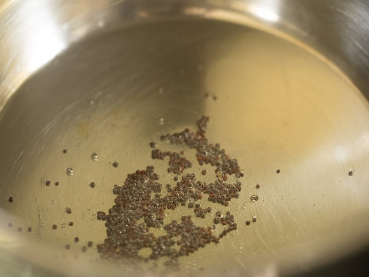 spluttering mustard seeds in hot oil in pan. 