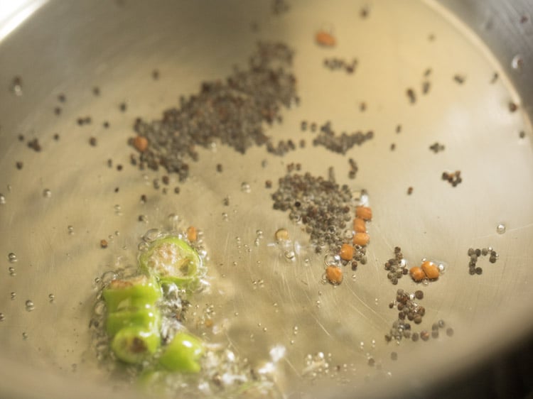 fenugreek seeds and chopped green chili added to the pan. 