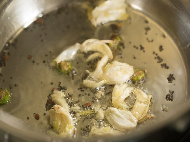 crushed garlic cloves added to the pan. 