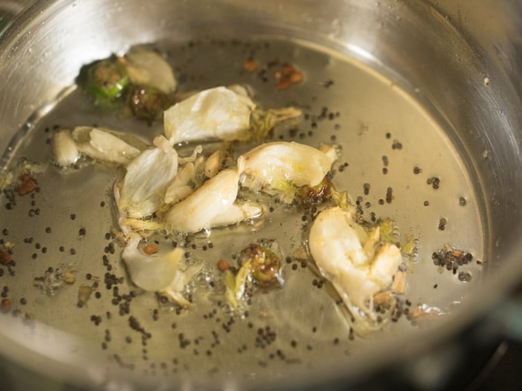 frying the garlic in the pan. 