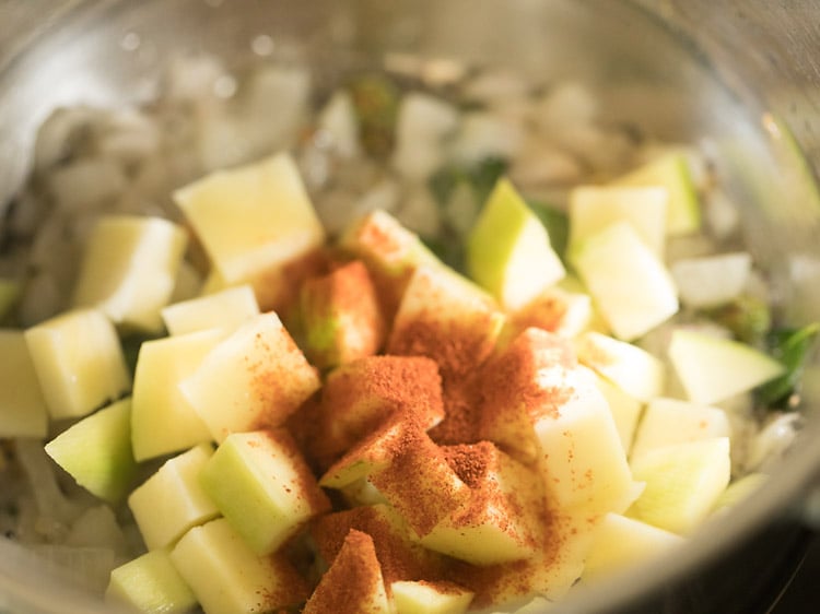 chopped raw mango cubes and red chili powder added in the pan. 