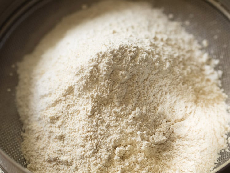 prepared urad dal flour added in the sieve. 