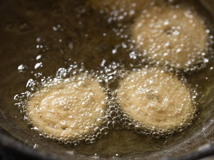 frying murukku in hot oil.
