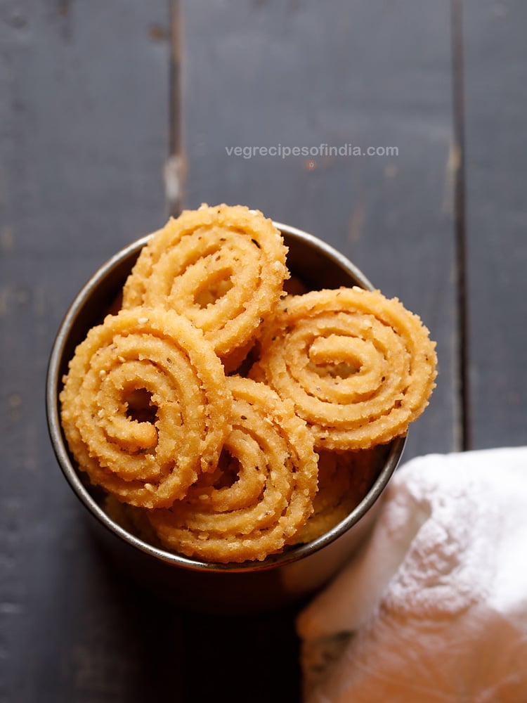 murukku served in a metal jar with text layover. 