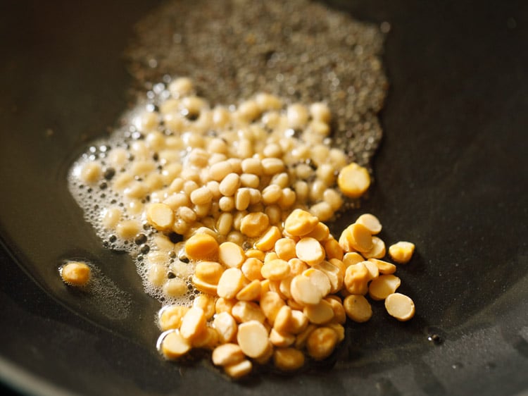 urad dal and chana dal added to hot oil. 