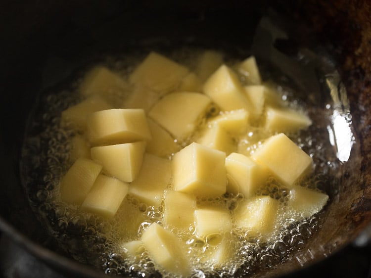 chopped potatoes frying in oil
