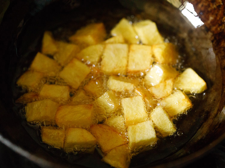 golden potato cubes frying