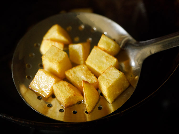 potato cubes removed with a slotted spoon