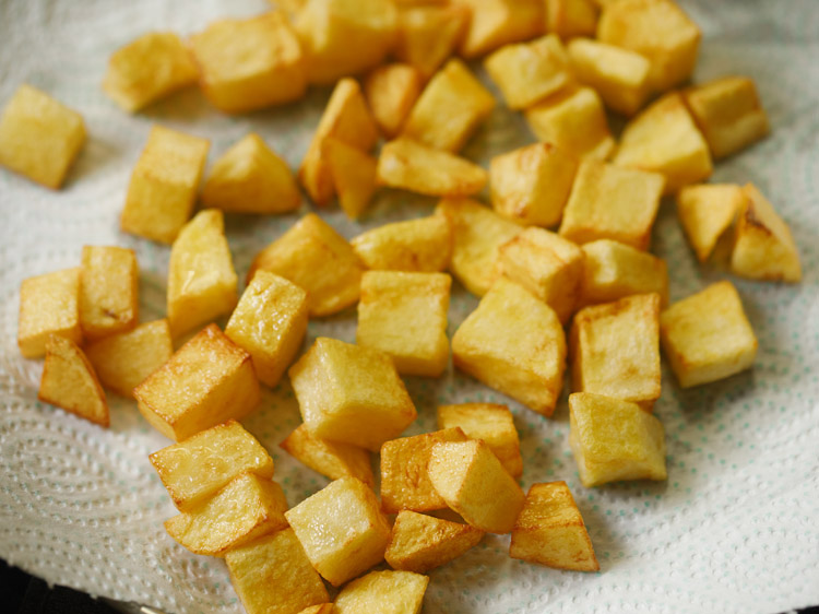 golden bite sized potatoes on a paper towel