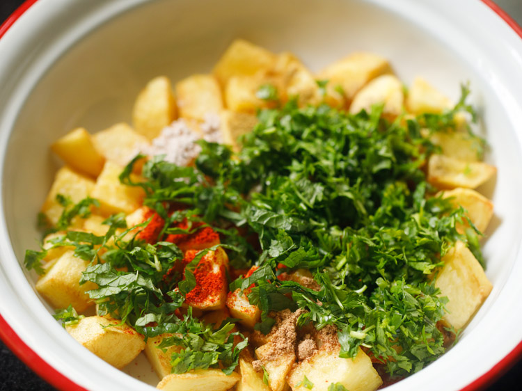 cooked cubed potatoes with spices, chopped coriander, mint leaves, and salt