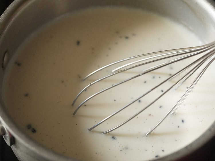 whisking milk mixture for making crème anglaise recipe.