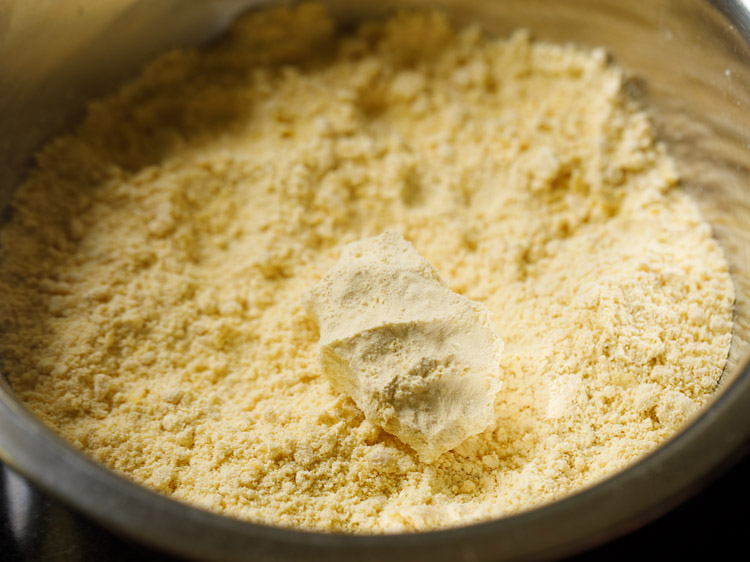 mixing flour mixture with the oil to form breadcrumb like texture for bhakarwadi recipe. 