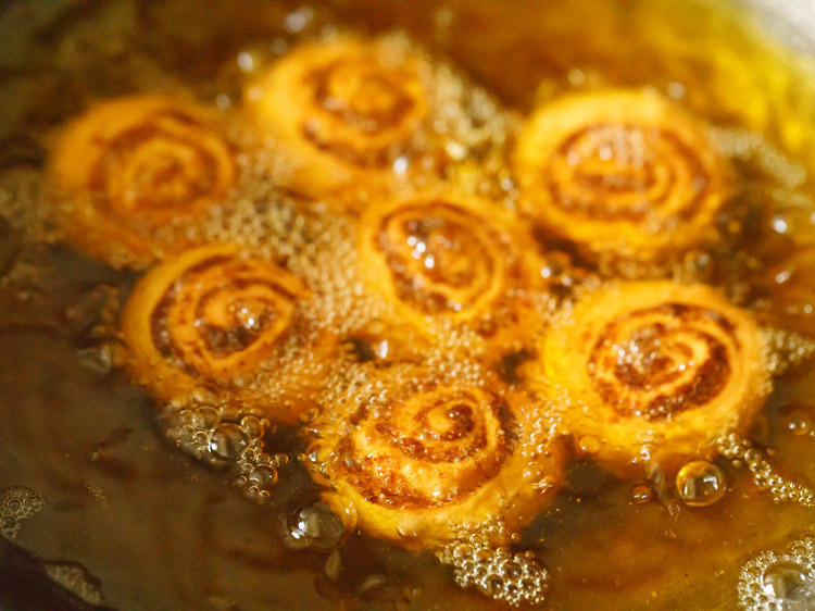 frying bakarwadi pinwheels till evenly golden and crisp from both sides. 