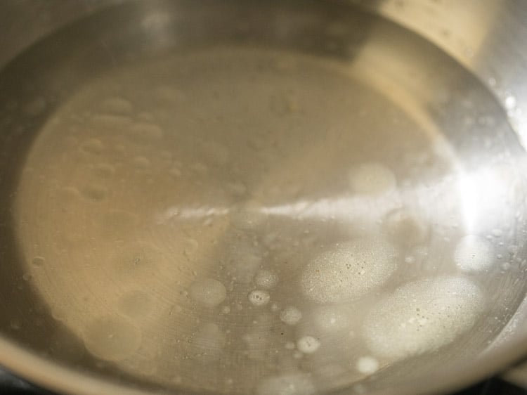 heating water to make rice dough for kozhukattai.
