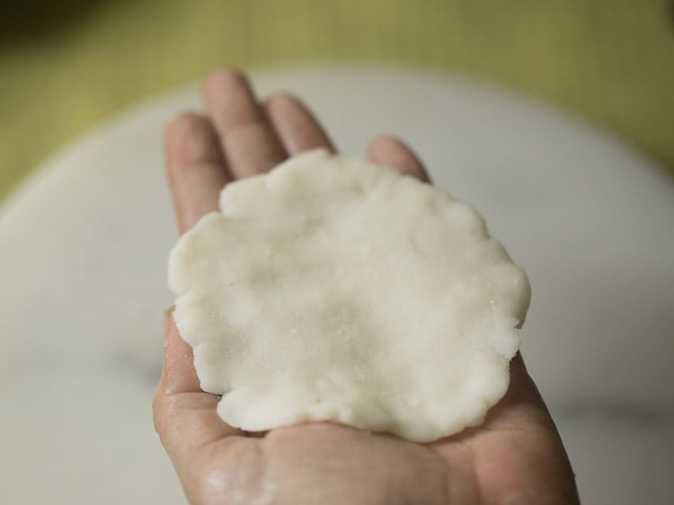 dough ball flattened and placed on the palm. 