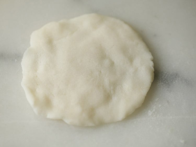 flattened dough placed on a plate. 