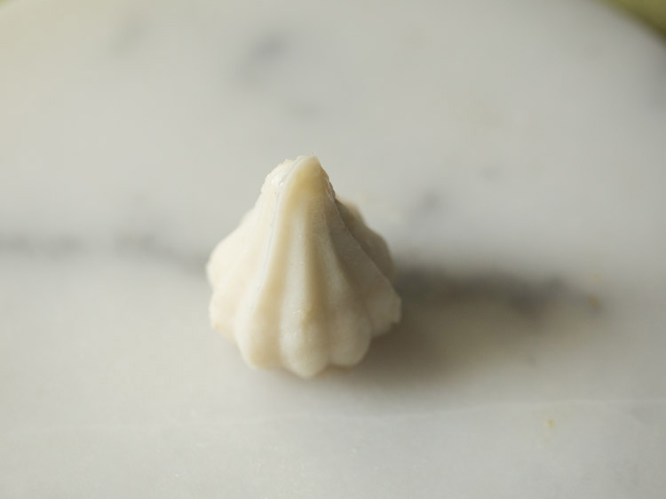 kozhukattai shaped using the mould. 