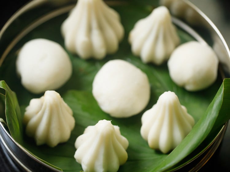 place shaped kozhukattais in a pan lined with turmeric leaves. 