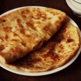 aloo kulcha in a white plate