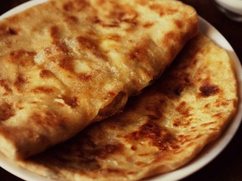 aloo kulcha in a white plate