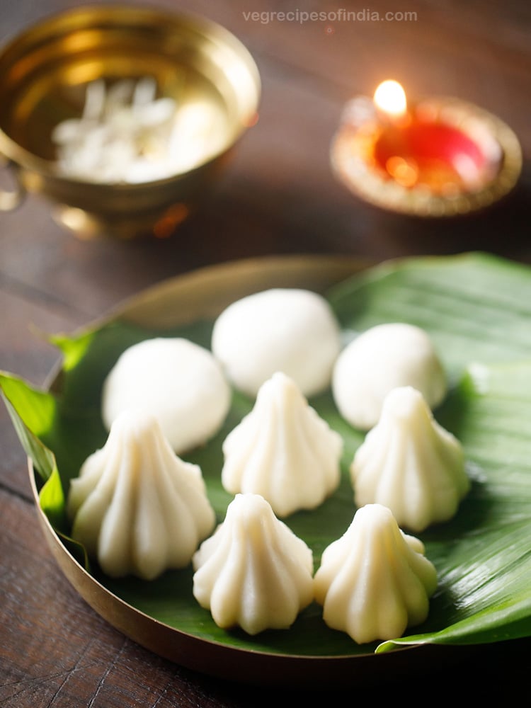 kozhukattai placed on turmeric leaves and served on a plate with text layovers. 