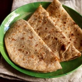 puran poli folded and served on a green color plate.