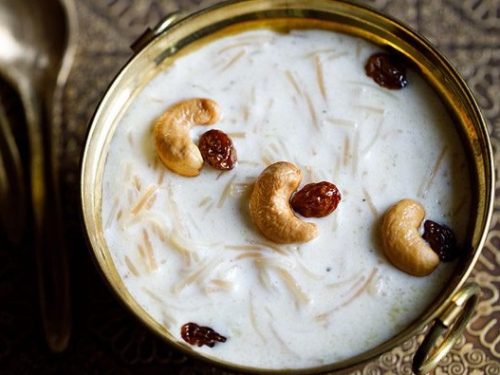 semiya payasam garnished with cashews and raisins in a brass bowl