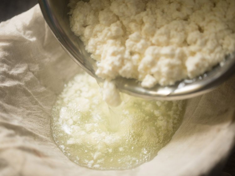 straining curdled milk through a muslin lined bowl. 