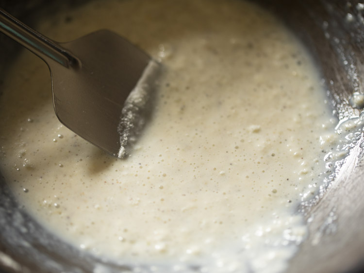 mixing ingredients in pan on low heat  for making stuffing for chom chom. 