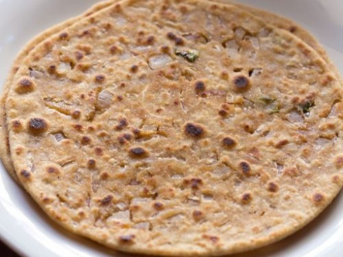 two onion paratha placed in a square white plate