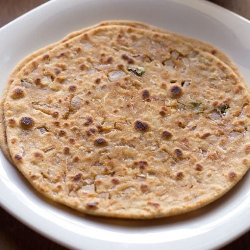 two onion paratha placed in a square white plate