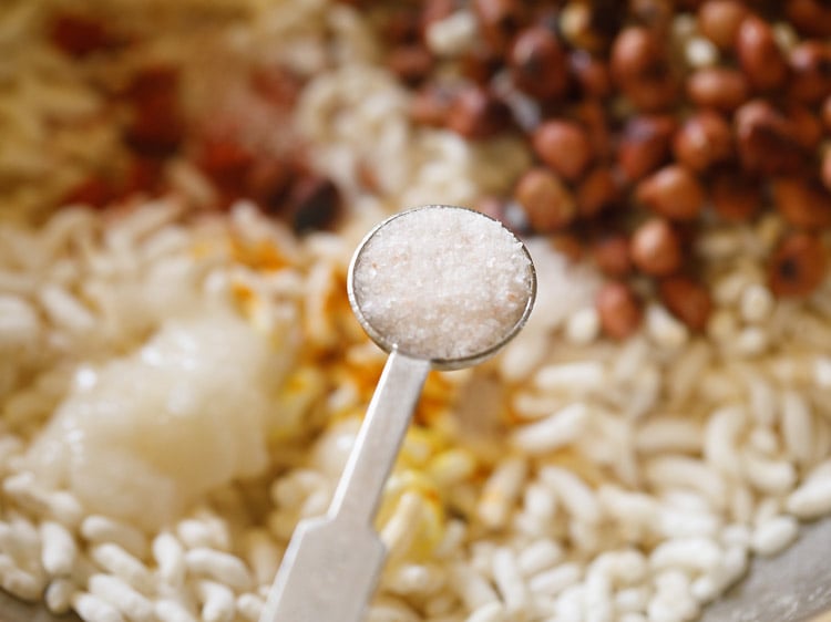 adding salt to the mandakki or puffed rice. 