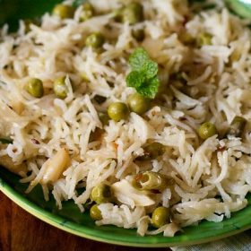 coconut milk pulao served on a green plate