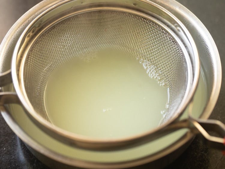 green colored whey inside the strainer and bowl