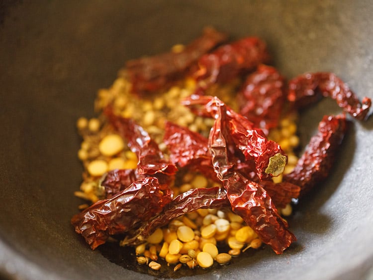 chillies added to spices mixture in pan