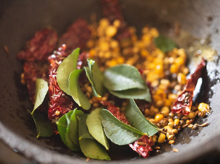 curry leaves added to spices mixture in pan