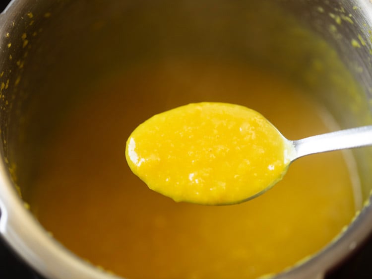 mashing lentils with a spoon