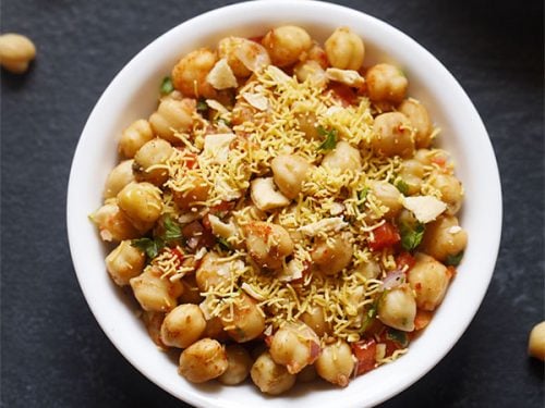 chana chaat served in a white bowl.