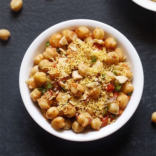 chana chaat served in a white bowl.