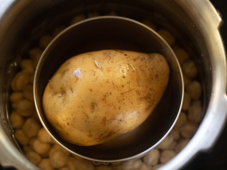 raw potato placed in a bowl in pressure cooker