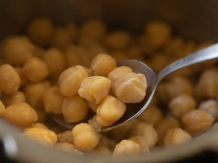 checking if chana are cooked by mashing them between your fingers or tasting them. 