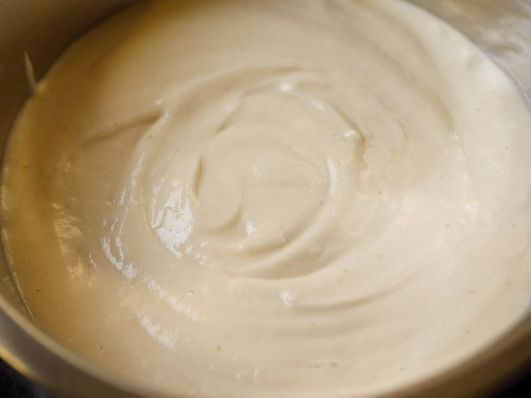 urad dal batter added in a bowl. 