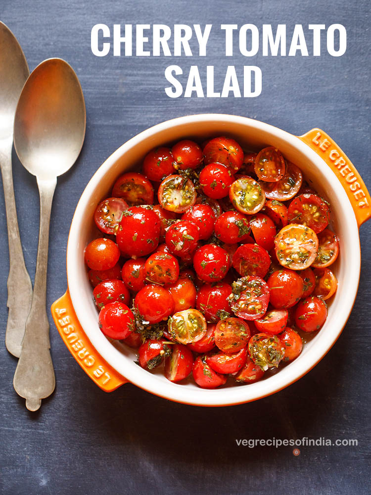 cherry tomato salad in a orange and cream colored flat bowl with text layovers.