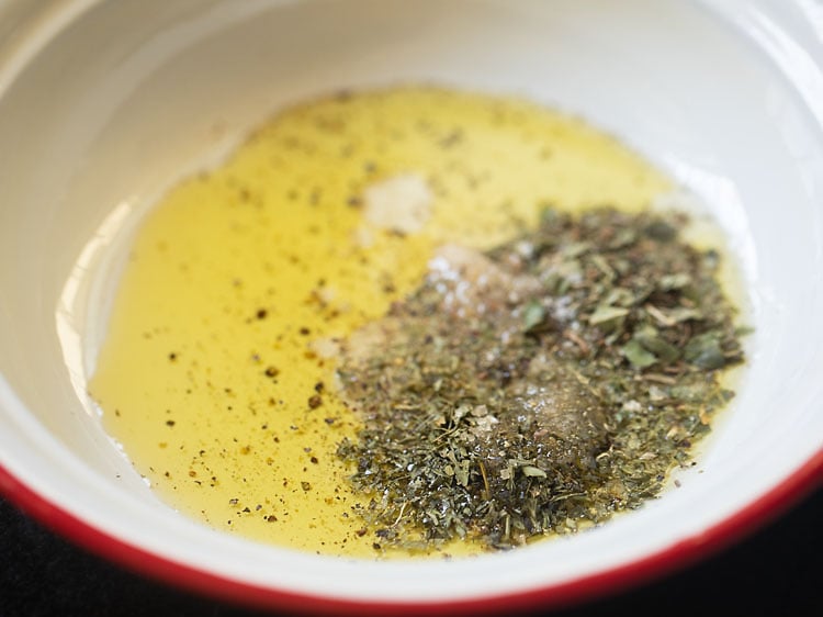 adding dried basil, dried parsley, sugar, crushed black pepper and salt in the dressing. 
