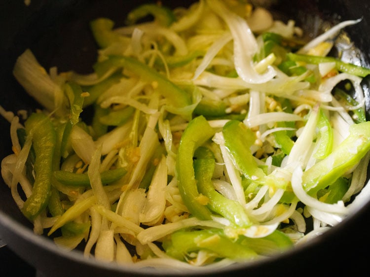 mixing onions and capsicum