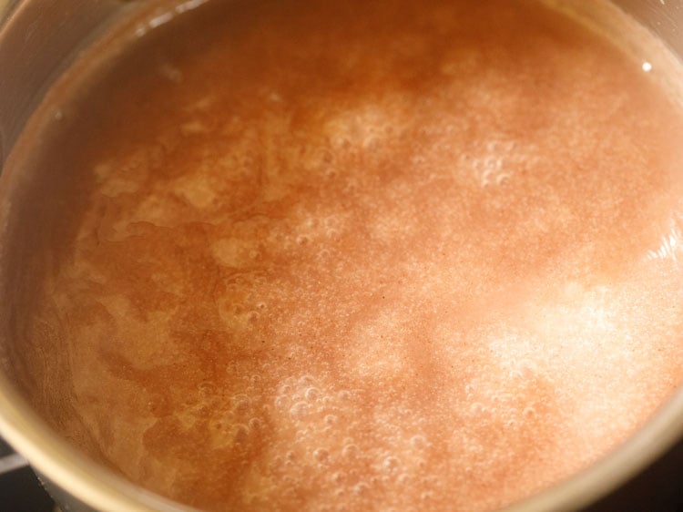 simmering and cooking ragi mixture on a low flame
