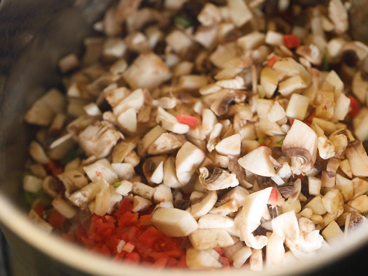 adding chopped mushrooms and carrots