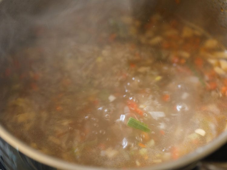 vegetables are cooked and the pot is steaming.