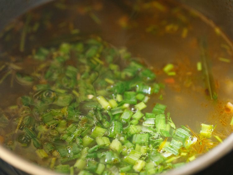 adding chopped spring onion greens